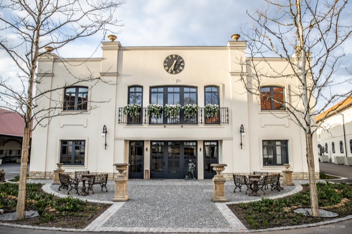 The manor's front facade, with courtyard seating