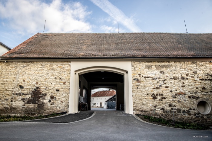 A stone archway passage through the stable block