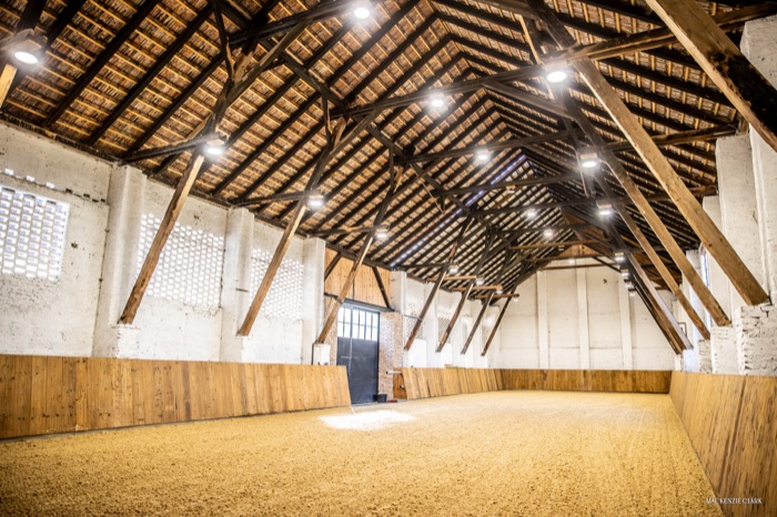 Angled view of the indoor arena's timber roof trusses